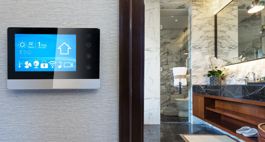 Smart home touchscreen on wall next to bathroom